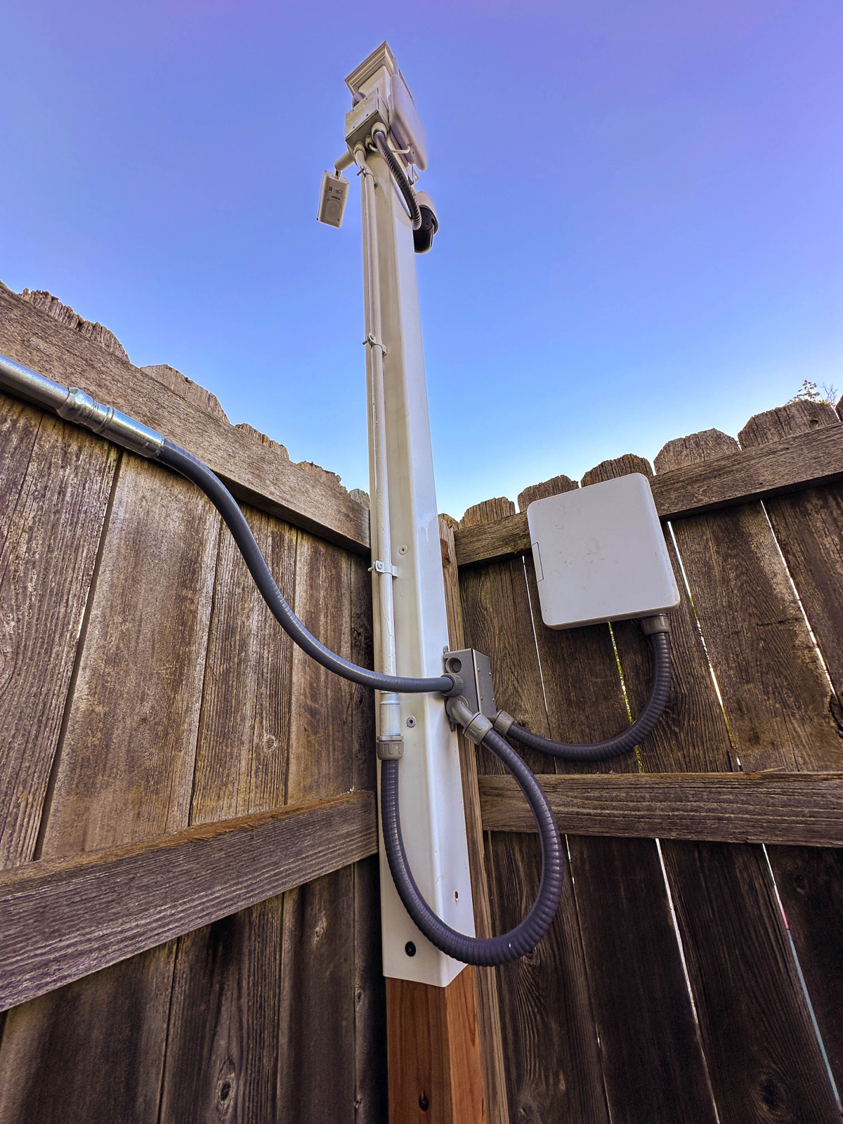 Pan-tilt camera on a post overlooking the vehicle lot