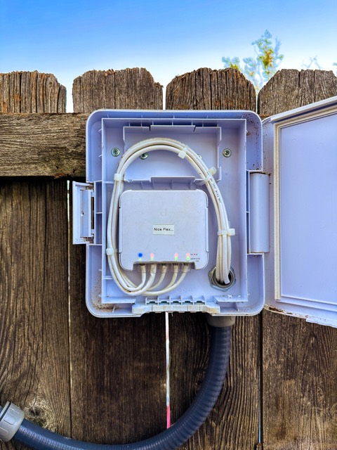 Weatherproof junction box opened to show cabling