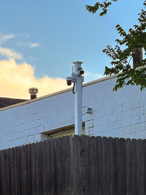 Post camera along the lot fence line
