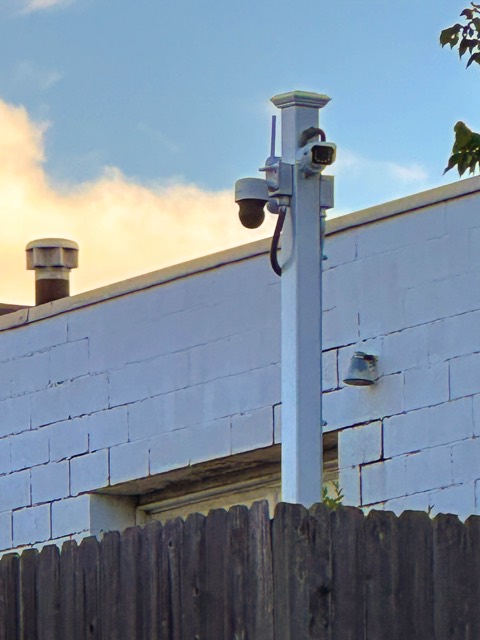 Cameras on the block building covering the rows of vehicles