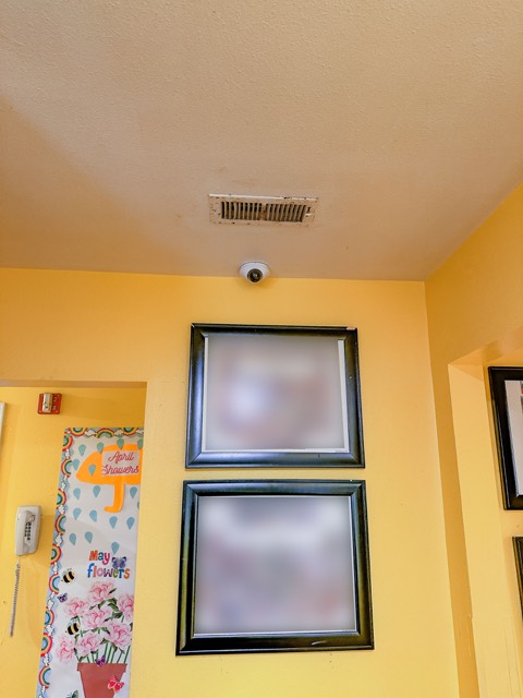 Camera and framed photos in the hallway