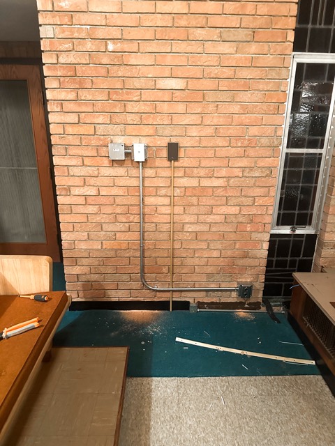 Conduit and box on the brick wall
