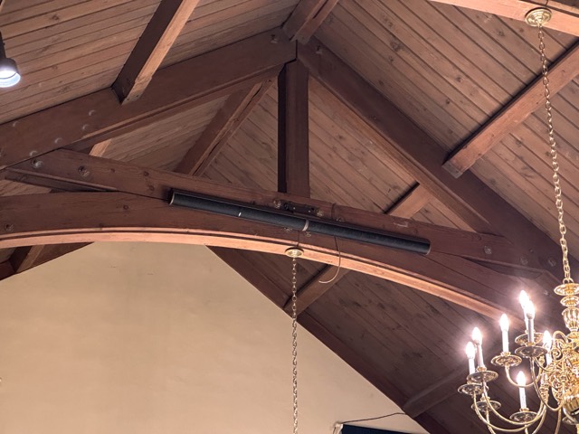 Speaker mounted on a beam in the fellowship hall