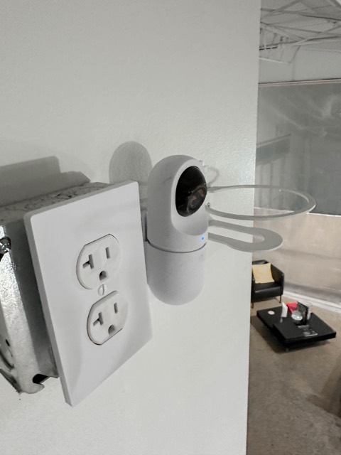 Compact camera beside a wall outlet