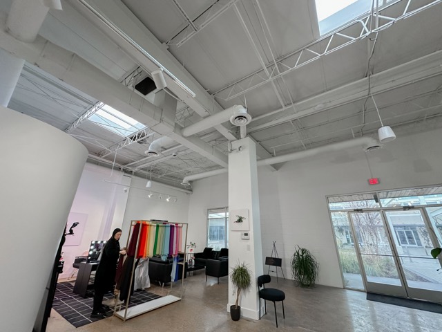 Open studio with fabric display wall and skylights