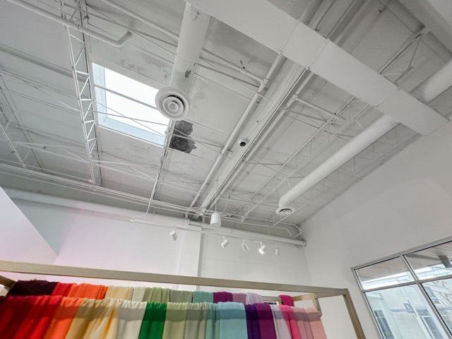 Pendant speaker above the fabric wall