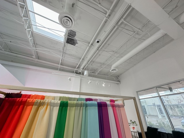 Fabric display wall with ceiling speaker