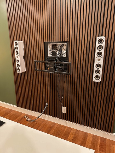 Slat wall with mount and speakers before the TV