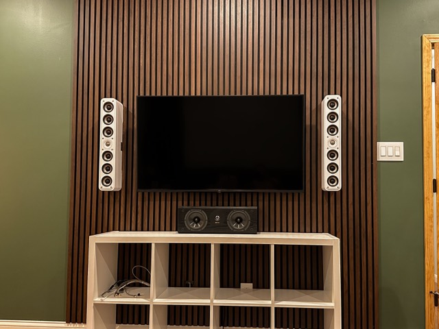 Bedroom wall with TV and built-in speakers