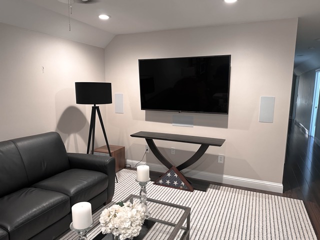Family room with mounted TV and in-wall speakers