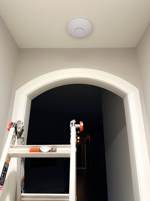 Access point centered above an arched hallway