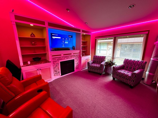 Media room lit in magenta by tunable LED lighting