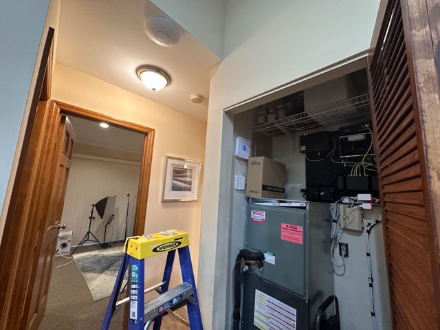 Utility closet with rack and ladder