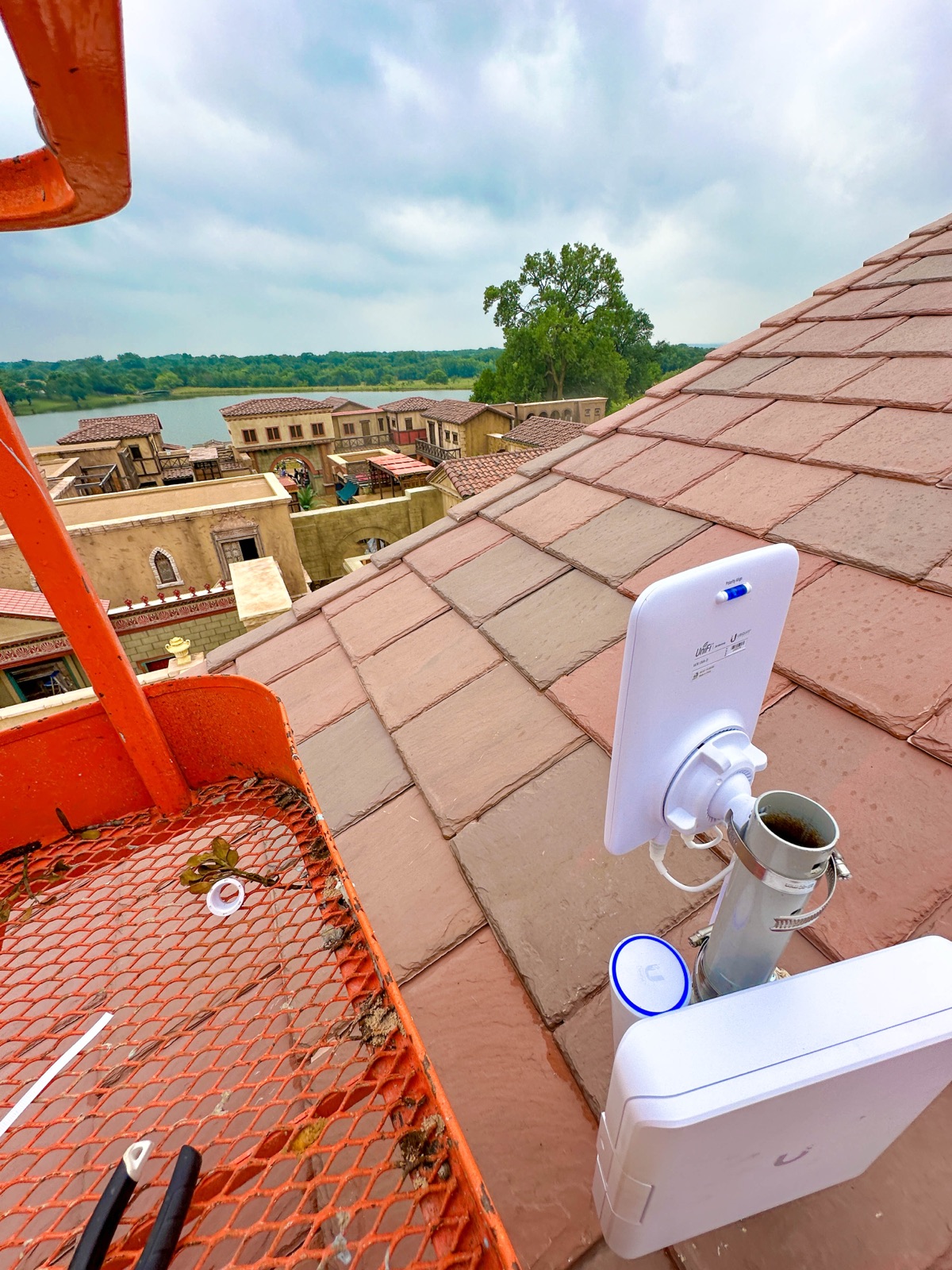Outdoor access point on a tile roofline, installed from a lift
