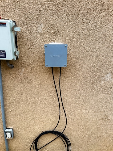 Sealed junction box on a stucco wall