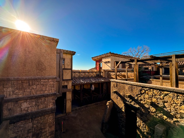Backlot rooftops against the sun