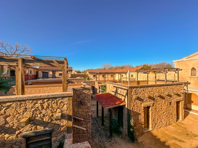 Looking down a backlot street from a rooftop