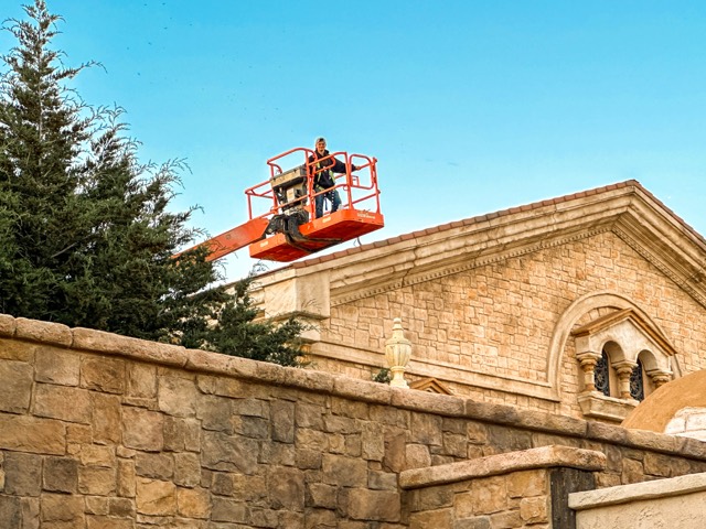Lift positioned against a stone set building