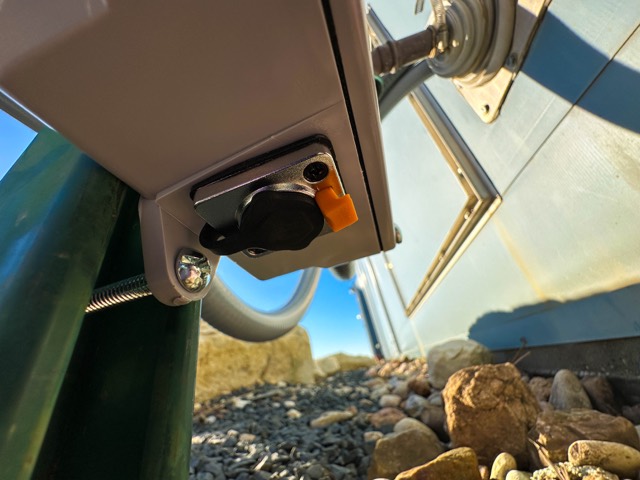 Outdoor junction box feeding conduit between buildings