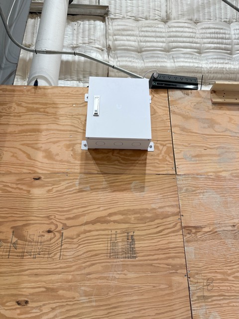 Junction box mounted on stage plywood