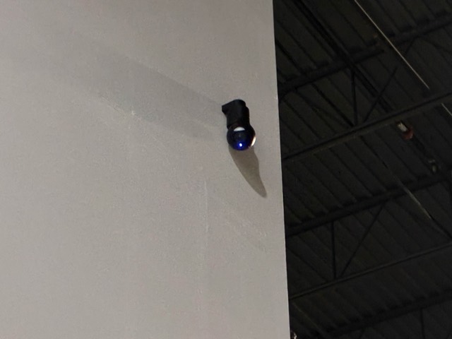 Wall-mounted security camera covering the warehouse floor