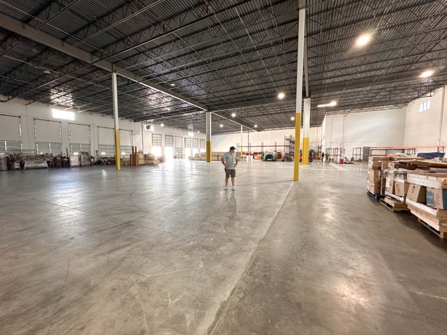 Empty production warehouse with steel racking before the network went in