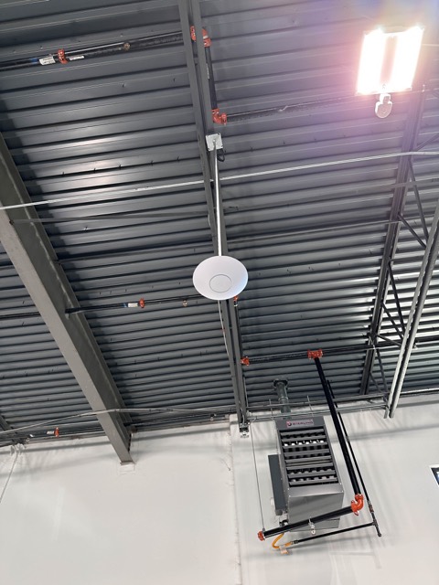 Access point mounted high on a warehouse beam
