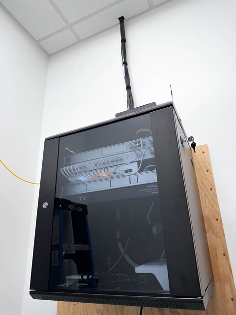 Wall-mounted network cabinet with switch and patch panel