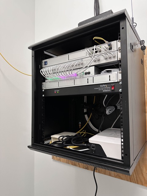 Open cabinet showing dressed patch cabling