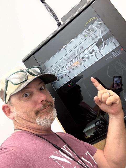 Pointing out the recorder in the cabinet