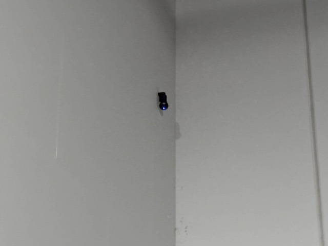Small camera aimed down a warehouse wall