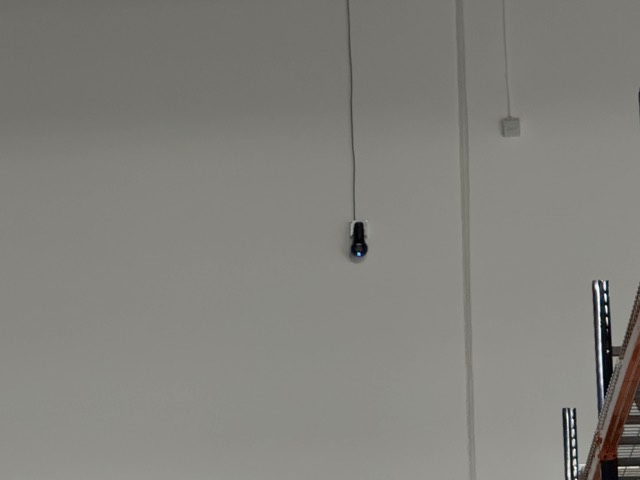 Camera mounted high on a warehouse wall