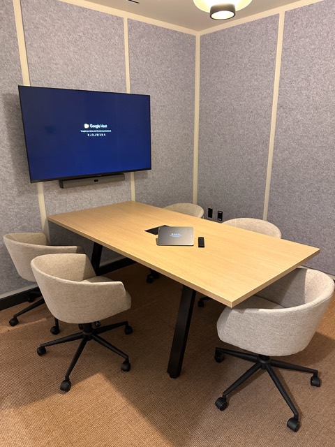 Huddle room with wall display and small table